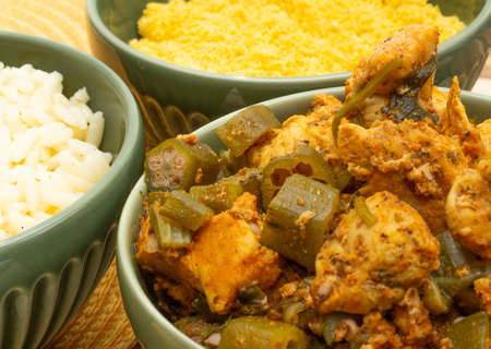 delicious brazilian meal in bowls full of piece of chicken, rice and flour on the wood backgroundの写真素材