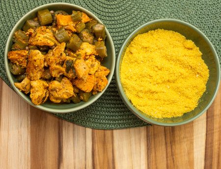 top view of delicious brazilian meal with bowls full of piece of chicken and "farofa" on the wood backgroundの写真素材
