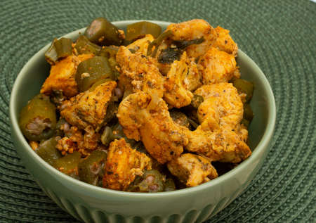 delicious brazilian meal in a bowl full of piece of chicken and okraの写真素材