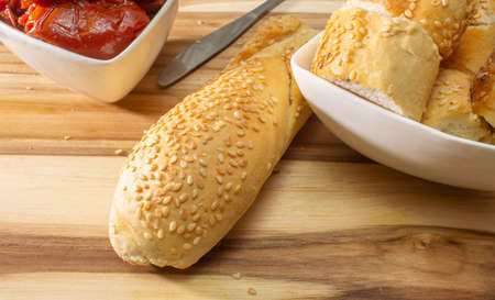 Bowl Full Of Dryied Tomato A Surrounding By Bread Covered With Sesameの写真素材
