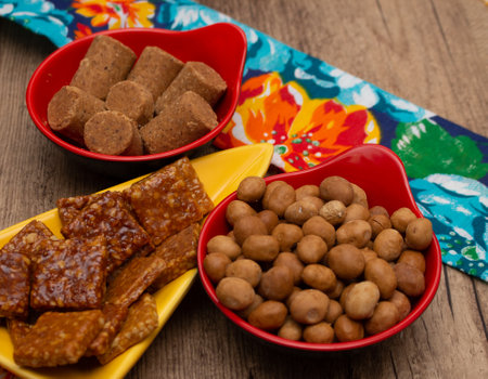 several bowls full of dried and sweet peanuts on the tableの写真素材