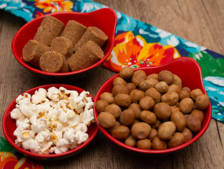 several bowls full of dried and sweet peanuts on the tableの写真素材