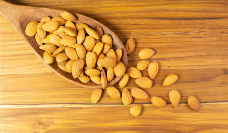 spoon full of dried fruits on the wood tableの写真素材