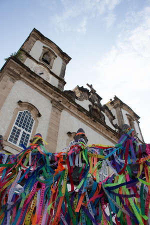 Salvador/ Bahia/ Brazil - 09/29/2019 - amazing view of church of lord of bonfim with several religious ribbons written Senhor do bonfim da bahia church in a cloudy dayのeditorial素材