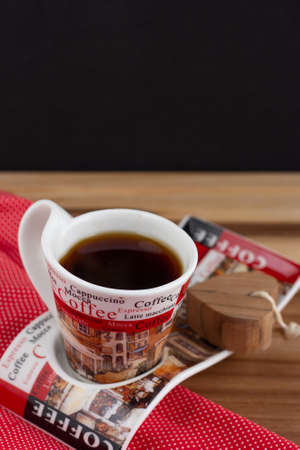 a cup of coffee under the wood table with a black backgroundの写真素材