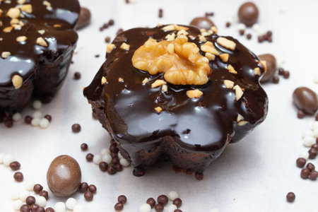 delicious chocolate candie with nuts on the top under the white tableの写真素材