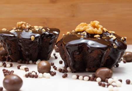 delicious chocolate candie with nuts on the top under the white tableの写真素材