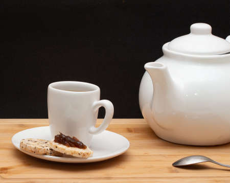 a cup of coffee surrounded by a coffee potの写真素材