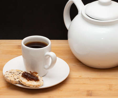 a cup of coffee beside a spoonの写真素材