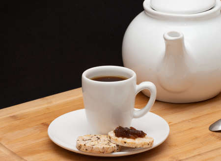 a cup of coffee surrounded by a coffee potの写真素材