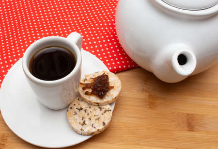 A cup of coffee under the straw table surrounded by aa coffee potの写真素材