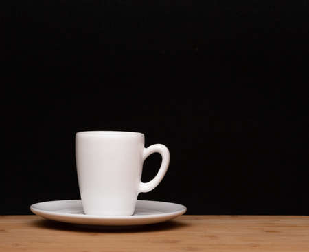 cup of coffee under the wood tableの写真素材