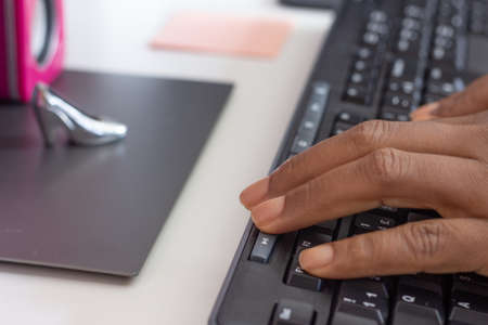 person typing on keyboard in front of a computerの写真素材