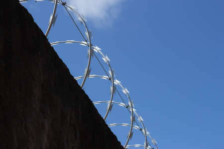 metal fence on a wall on a sunny dayの写真素材