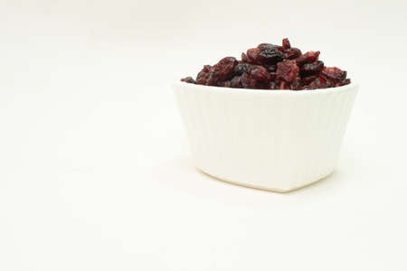 small white bowl full of cranberriesの写真素材