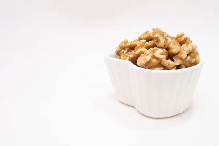 small white bowl full of almondsの写真素材