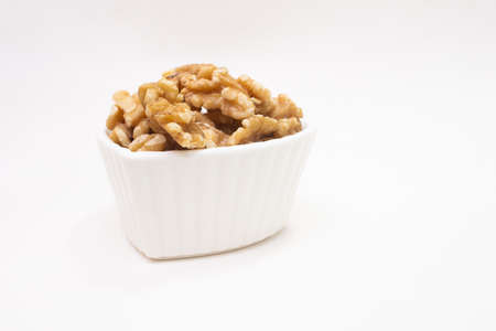 small white bowl full of almondsの写真素材