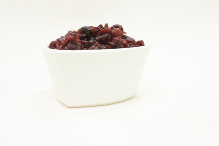 small white bowl full of cranberriesの写真素材