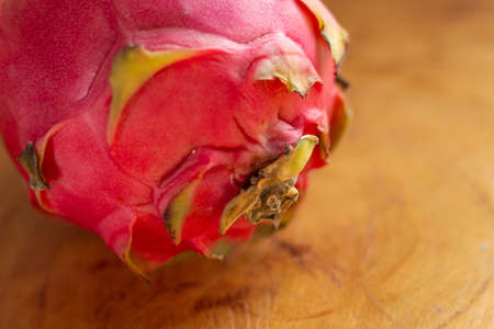 a pitaya fruit on a wooden tableの写真素材