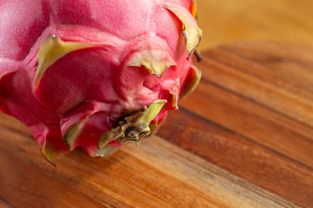a pitaya fruit on a wooden tableの写真素材