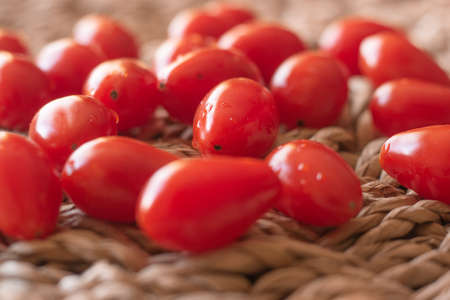 tomatoes on to a straw tableの写真素材