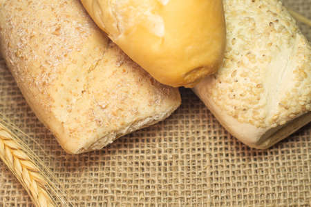 top view of three kind of bread on a straw table