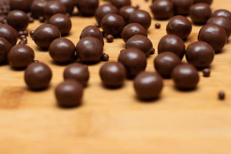 different types of chocolate balls on a wooden table