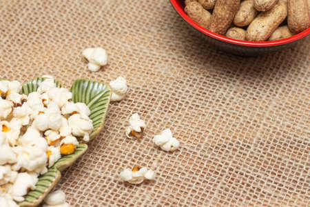 brazilian june party snacks like popcorn, peanuts and corn on straw backgroundの写真素材
