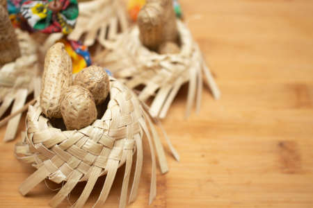 small straw hats filled with peanuts with Brazilian festa junina decorations