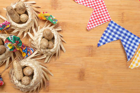 small straw hats filled with peanuts with Brazilian festa junina decorations