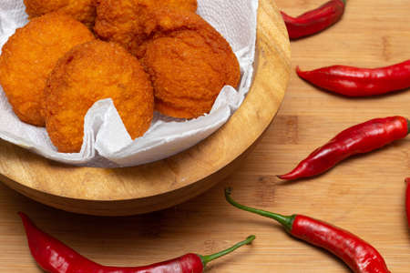 Traditional Brazilian black-eyed pea dumplings in a bowl surrounded by peppers - Typical food from Bahiaの写真素材