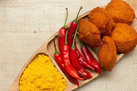 Traditional Brazilian black-eyed pea dumplings with red peppers and palm oil farofa - typical food from Bahiaの写真素材