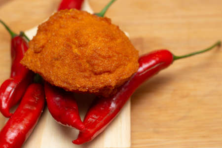 Traditional Brazilian black-eyed pea dumplings over red peppers - Typical food from Bahia.の写真素材