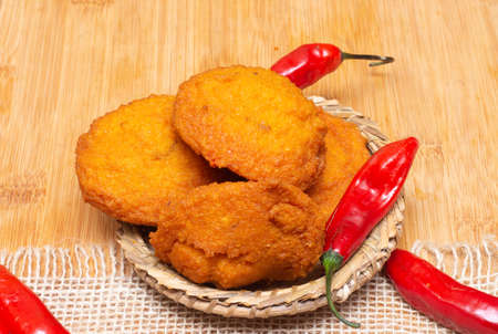 typical food from Bahia called acarajÃ© surrounded by red peppers