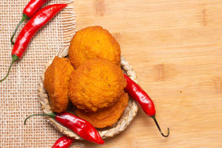 typical food from Bahia called acarajÃ© surrounded by red peppers