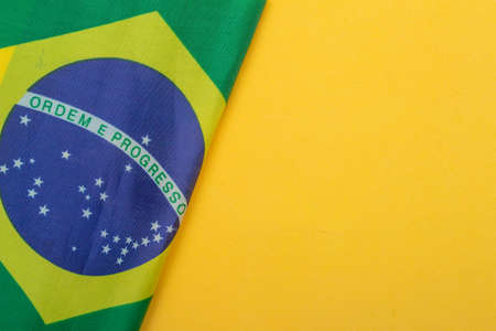 brazilian flag under yellow backgroundの写真素材