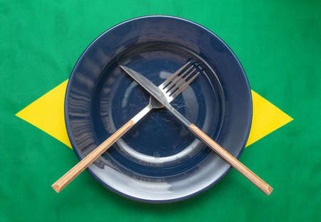 empty plate with cutlery over brazilian flag