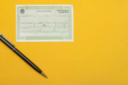 brazilian election document near pen under yellow background