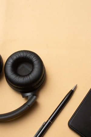 smartphone and headset on beige background table - officeの写真素材