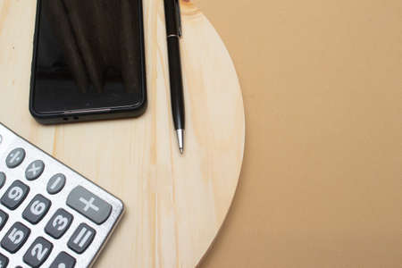 calculator and a pen on the office table