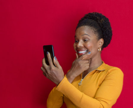 black woman in green clothes making a gesture on a yellow background