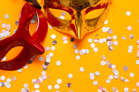 top viewtwo colored masks on an orange background with ornamentsの写真素材