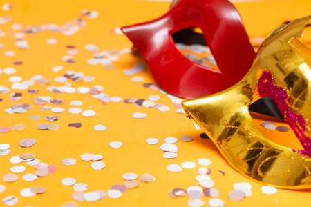 two colored masks on an orange background with ornamentsの写真素材