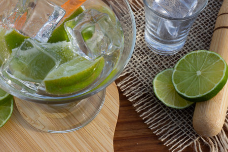 brazilian drink (caipirinha) on the table with ingredients in a sunny day