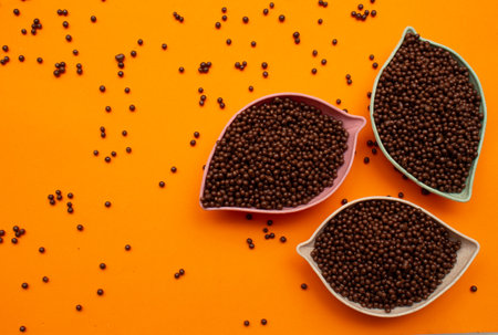 baskets of chocolate balls on an orange backgroundの写真素材