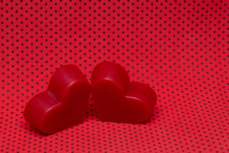 two red hearts on a red background (valentine's day)の写真素材