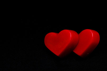 two red hearts on a black background (valentine's day)の写真素材