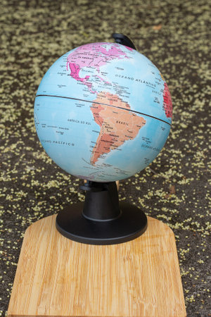 earth globe on a beige textured background showing continent South and North America