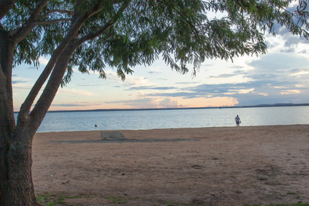 people enjoying the sunset next to a riverの写真素材