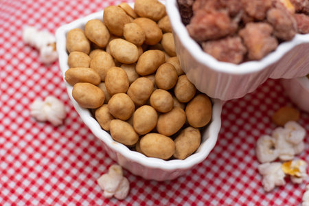 bowl full of sweet and salty peanuts and popcorn - brazilian june partyの写真素材